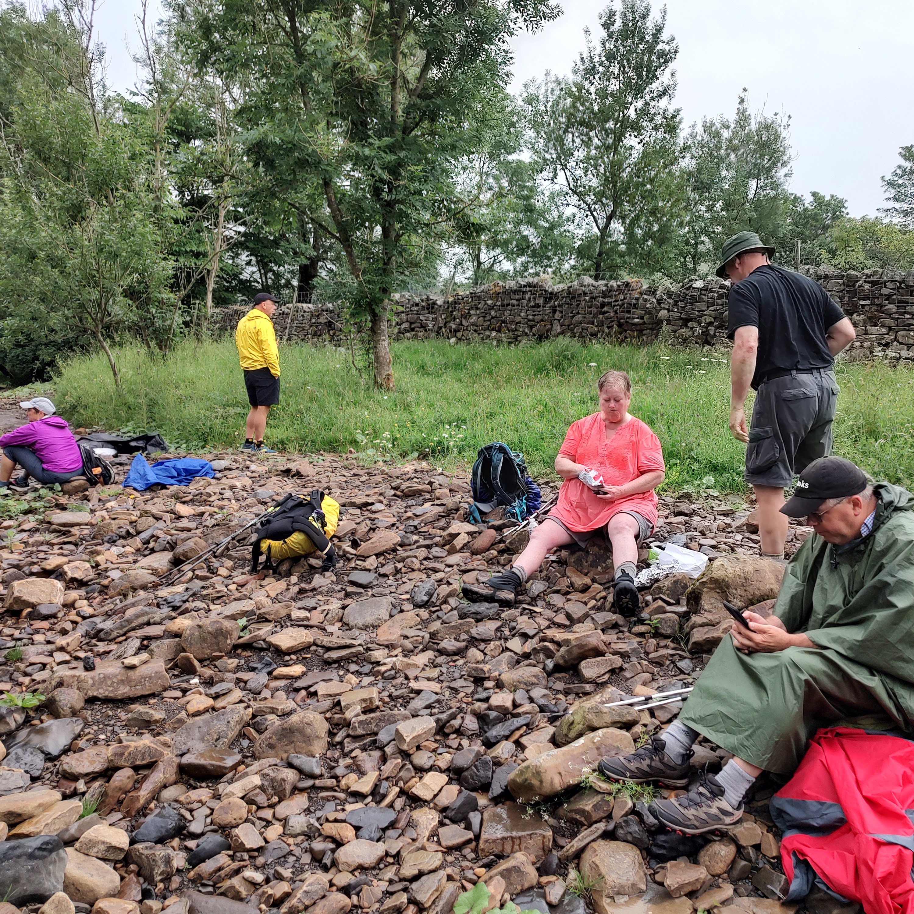 Hikers resting on a rocky trail